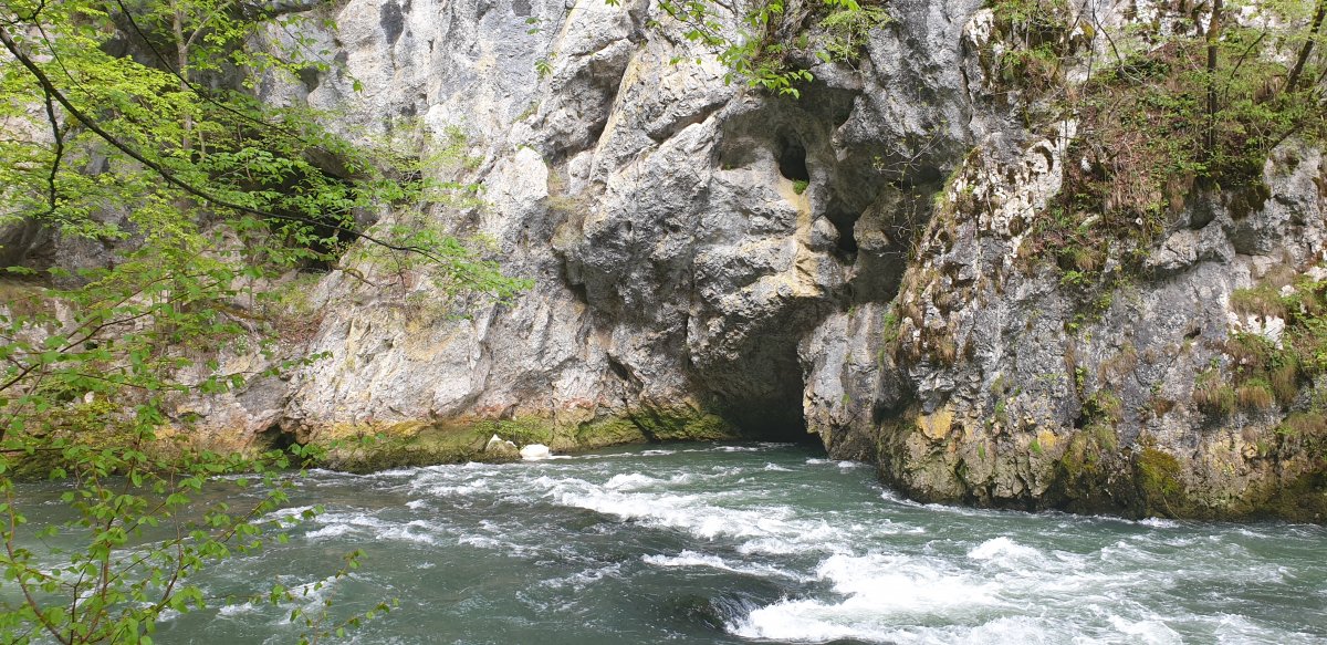 the River Unica thunders out of the cave mouth and powers along right next to your feet..