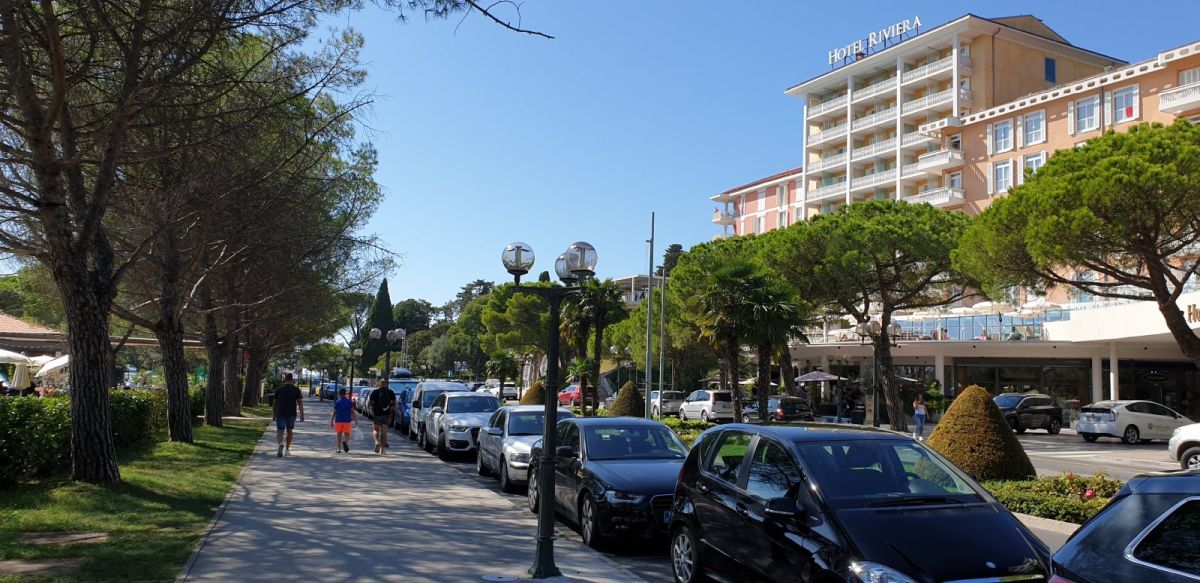 long high street promenade lined with medium size hotels and shops..
