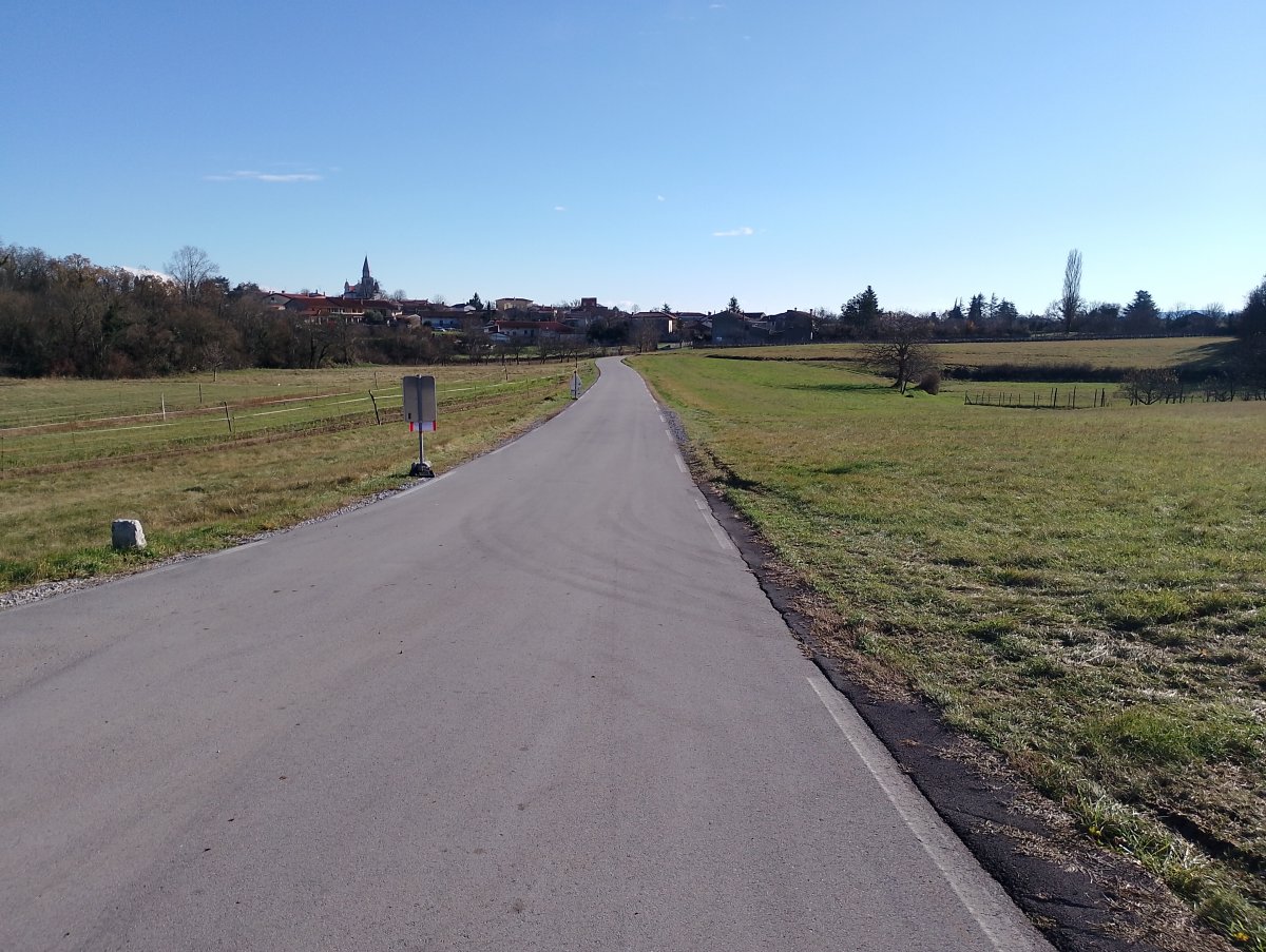 Typical Red Karst scene with empty roads, wide open meadows and a cute little village with church and high steeple..